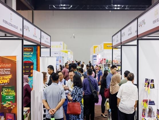 Visitors networking in exhibition aisles lined with stands at Food & Drinks Malaysia by SIAL.