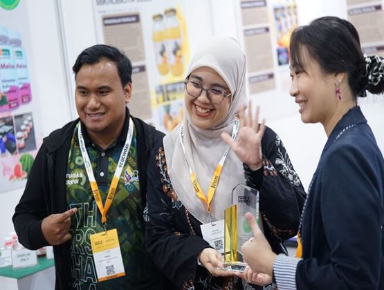 Food & Drinks Malaysia by SIAL participants celebrate during an award presentation at the exhibition.
