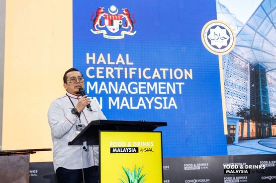 Speaker presenting on halal certification management in Malaysia during a Food and Drinks Malaysia event 