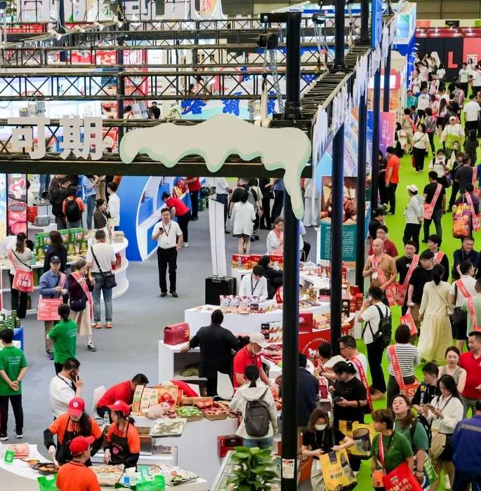 A lively aerial view of SIAL Shanghai, with numerous visitors exploring stands and displayed products.
