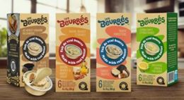 Four Les Beurrés boxes lined up, showing several savory butter varieties.