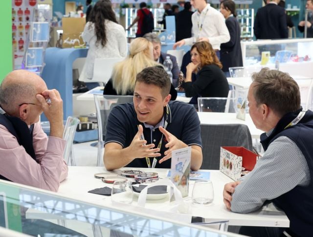 Buyers discussing around a table during a B2B meeting at an international food trade show
