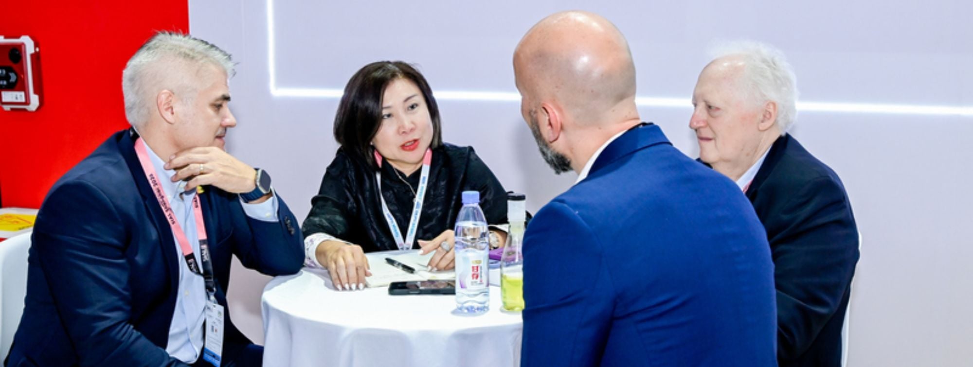 Professionals discussing during a premium buyers meeting at an international trade show
