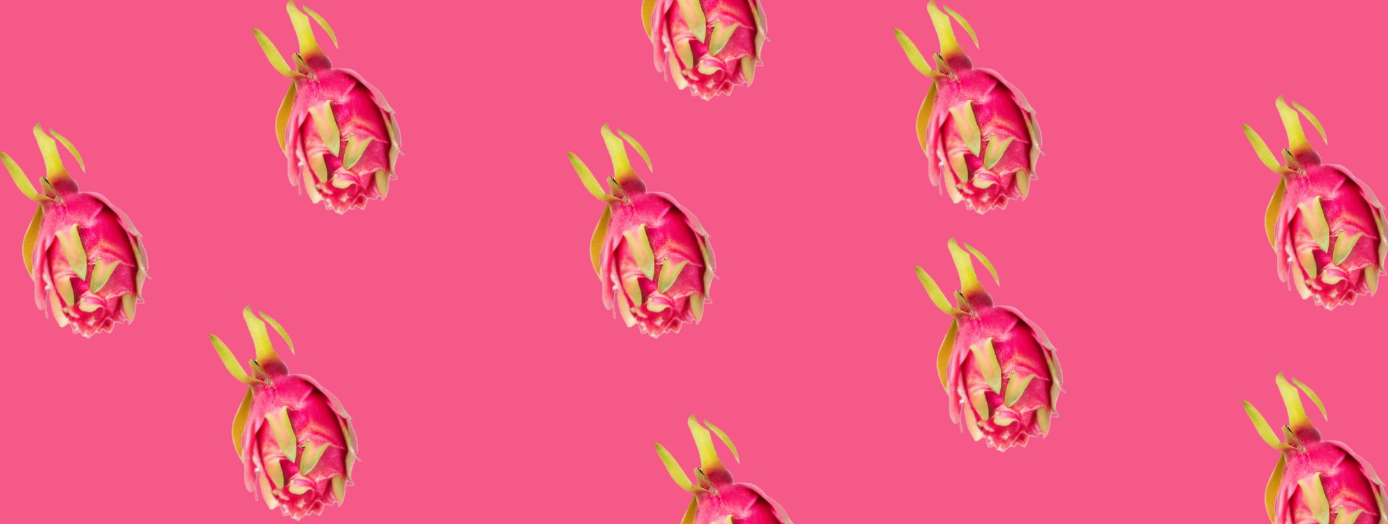 Dragon fruits arranged in a repeating pattern on a bright pink background.
