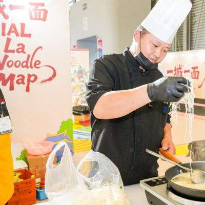 Chef demonstrating traditional noodle preparation at the SIAL La Noodle Map culinary showcase.