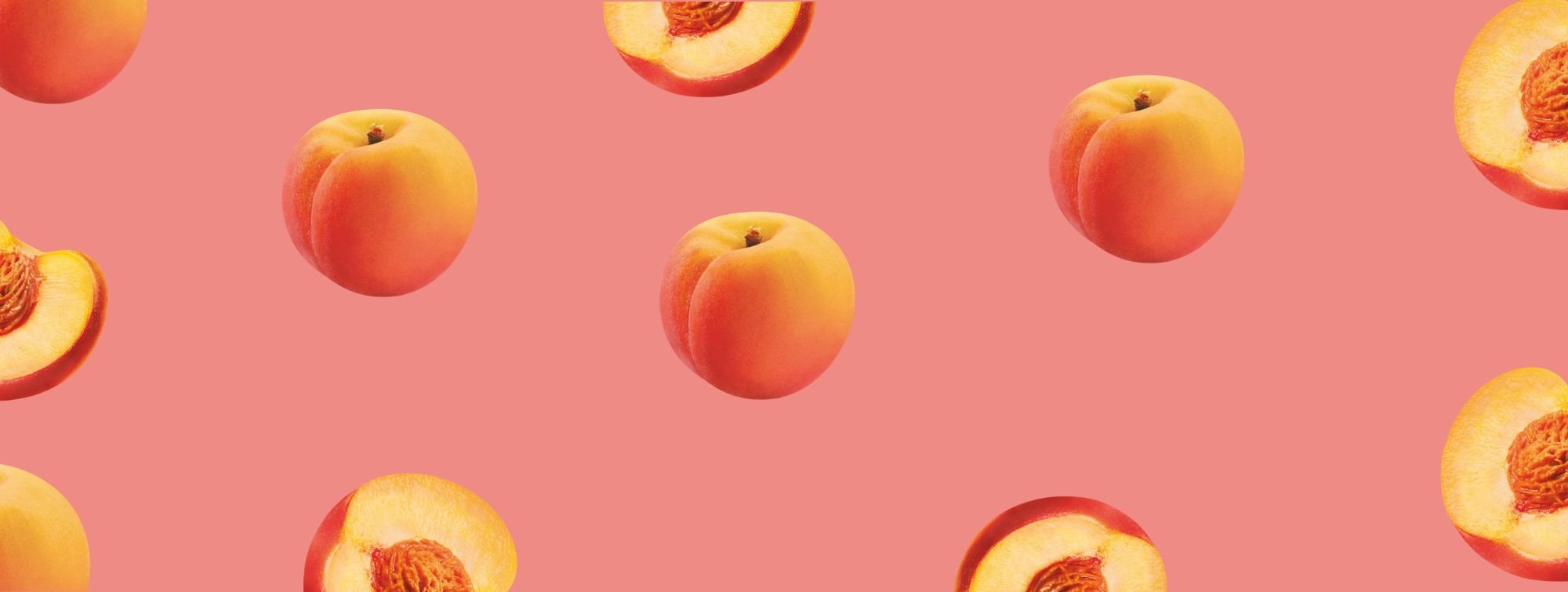 Seamless pattern of whole and sliced peaches on coral pink background