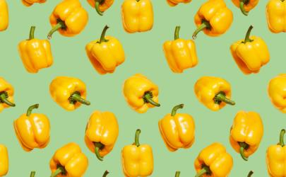 Yellow bell peppers on a green background
