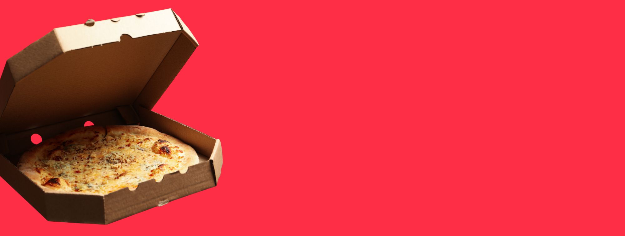 Pizza in an open cardboard box with a red background