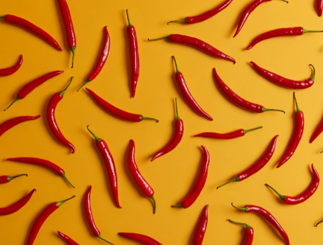 red chillies orange background