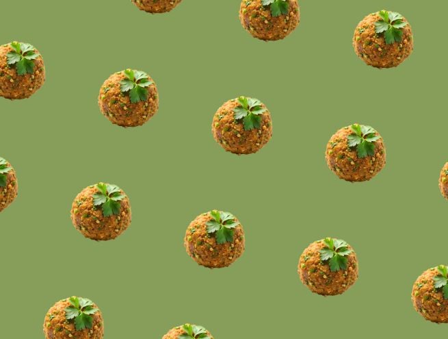 Falafel balls on green background