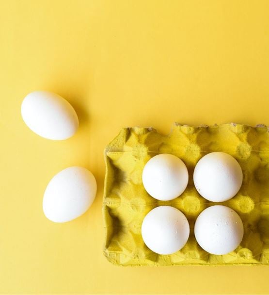 White eggs on yellow background